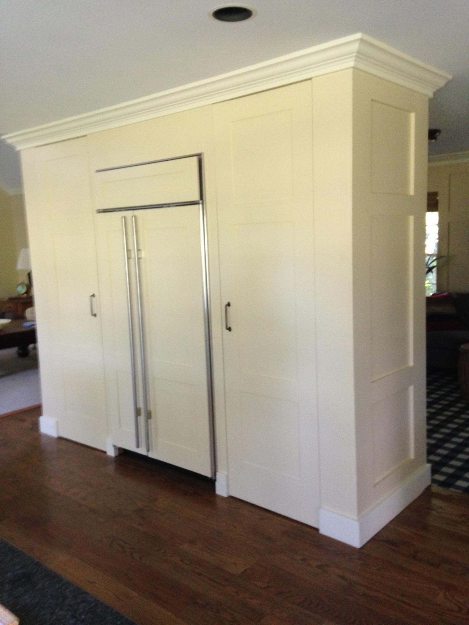 Fabricated and installed paneling on sub zero refrigerator and doors of pantry flanking either side
