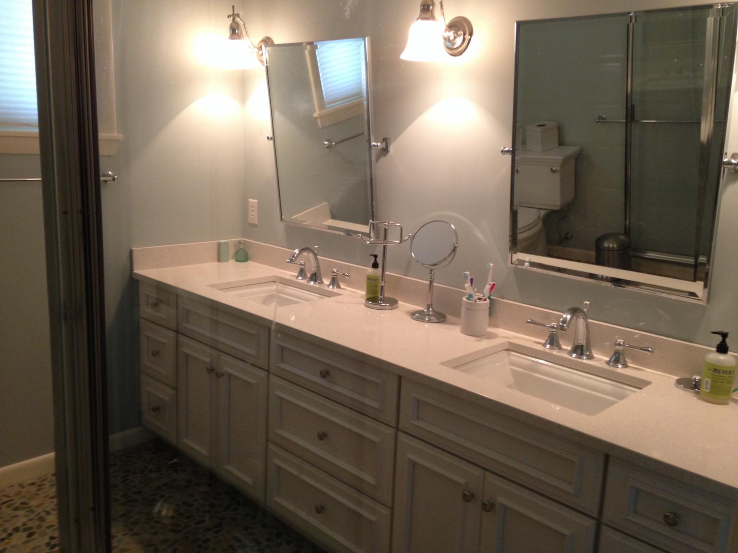 Bathroom remodel, installed new tile floor, vanities, mirrors, lights and painted walls